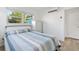 Bright bedroom with natural light, a striped bedspread and white furniture at 4519 Brooksdale Dr, Sarasota, FL 34232
