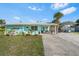 Charming single-story home featuring a well-manicured lawn and a convenient covered carport at 4519 Brooksdale Dr, Sarasota, FL 34232