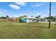Charming light blue home with lush front lawn, mature trees, and inviting curb appeal in a peaceful neighborhood at 4519 Brooksdale Dr, Sarasota, FL 34232