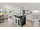 Bright kitchen featuring white cabinets, stainless steel appliances, and a central island with seating at 4519 Brooksdale Dr, Sarasota, FL 34232