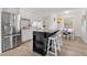 Well-lit kitchen featuring stainless steel appliances and an island, flowing into an adjacent dining area at 4519 Brooksdale Dr, Sarasota, FL 34232