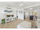 Bright and airy living room with a ceiling fan and entertainment center next to the open kitchen at 4519 Brooksdale Dr, Sarasota, FL 34232