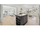 Spacious open concept living room with stylish center island, light wood flooring, and bright interiors at 4519 Brooksdale Dr, Sarasota, FL 34232