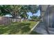 Expansive, well-maintained back yard featuring a tall wooden fence for privacy and a storage shed at 4611 Spahn St, Sarasota, FL 34232