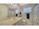 Well-lit bathroom with a vanity featuring a marble countertop and matching nautical decor at 4611 Spahn St, Sarasota, FL 34232