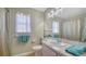 Bright bathroom featuring a marble countertop, a large mirror, and coordinated blue towels at 4611 Spahn St, Sarasota, FL 34232
