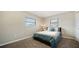 Cozy bedroom with plush carpeting, neutral walls, and two windows providing natural light at 4611 Spahn St, Sarasota, FL 34232