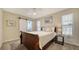 Charming bedroom with a sliding barn door for the bathroom and a bright window at 4611 Spahn St, Sarasota, FL 34232