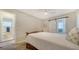 Serene bedroom showcases sliding barn door to bathroom, bright window, and neutral decor at 4611 Spahn St, Sarasota, FL 34232