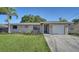 Inviting single-story home with a freshly landscaped yard and a cozy seating area near the entrance at 4611 Spahn St, Sarasota, FL 34232