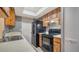 Efficient kitchen features wood cabinets and black appliances with ample counter space at 4611 Spahn St, Sarasota, FL 34232