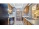 Efficient kitchen with wood cabinets, black appliances, and a view into the dining room at 4611 Spahn St, Sarasota, FL 34232