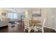 Open-concept living and dining area with wood floors and a view of the living room at 4611 Spahn St, Sarasota, FL 34232