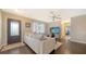 Comfortable living room with wood floors, a ceiling fan, and a view into the bedroom hallway at 4611 Spahn St, Sarasota, FL 34232