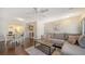 Spacious living room with a dining area featuring wood floors, leading to a fireplace at 4611 Spahn St, Sarasota, FL 34232
