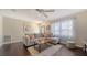 Cozy living room with a large sectional sofa, wood floors and natural light from the window at 4611 Spahn St, Sarasota, FL 34232