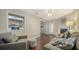 Inviting living area with hardwood floors, modern gray furniture and a fireplace, next to the kitchen at 4611 Spahn St, Sarasota, FL 34232