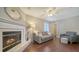 Cozy living room features a fireplace, hardwood floors, and comfortable gray couch and armchair at 4611 Spahn St, Sarasota, FL 34232