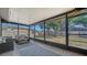 Spacious screened porch with outdoor seating, offering views of the backyard and natural light at 4611 Spahn St, Sarasota, FL 34232