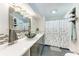 Modern bathroom featuring a unique vessel sink, sleek countertops, contemporary fixtures, and a decorative shower curtain at 4907 18Th W Ave, Bradenton, FL 34209