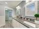 Modern bathroom featuring double sinks, granite countertops, and a walk-in shower at 4907 18Th W Ave, Bradenton, FL 34209
