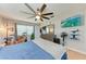Comfortable bedroom with a large fan, TV, drums, natural light, and ample space for relaxation and entertainment at 4907 18Th W Ave, Bradenton, FL 34209