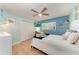Inviting bedroom with hardwood floors, ceiling fan, closet, blue accent wall, and a cozy bed perfect for relaxation at 4907 18Th W Ave, Bradenton, FL 34209