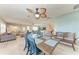 Open concept dining area with seating for six and decorative ceiling fan extending into the living area at 4907 18Th W Ave, Bradenton, FL 34209