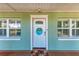 Charming front door with decorative wreath, flanked by windows, creating a welcoming entryway at 4907 18Th W Ave, Bradenton, FL 34209