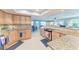 Well-lit kitchen with granite countertops and tile flooring that opens to the dining and living areas at 4907 18Th W Ave, Bradenton, FL 34209