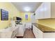 Well-equipped laundry room with washer, dryer, sink, ample counter space, and storage cabinets at 4907 18Th W Ave, Bradenton, FL 34209
