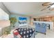 Comfortable living room with beach view TV, open to kitchen with bar stool seating at 4907 18Th W Ave, Bradenton, FL 34209