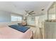 Bright main bedroom featuring a ceiling fan, custom wall trim, and a desk area at 4907 18Th W Ave, Bradenton, FL 34209