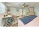 Bright main bedroom featuring a ceiling fan, custom wall trim, and a desk area with storage at 4907 18Th W Ave, Bradenton, FL 34209