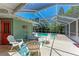 Outdoor patio with comfortable seating, fire pit, and screened-in pool views, creating an ideal space for relaxation and gatherings at 4907 18Th W Ave, Bradenton, FL 34209