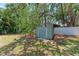 Backyard shed nestled among trees for storing garden tools and equipment at 4907 18Th W Ave, Bradenton, FL 34209