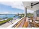Balcony overlooking harbor, furnished with chairs and ceiling fan at 516 Tamiami S Trl # 306, Nokomis, FL 34275