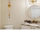 Elegant half bath featuring a marble counter, designer fixture and a decorative mirror at 516 Tamiami S Trl # 306, Nokomis, FL 34275