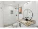 Modern bathroom with glass shower, granite sink counter, round mirror, and sleek, minimalist design at 516 Tamiami S Trl # 306, Nokomis, FL 34275