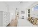 Serene bedroom with wood-look floors, large windows, and a chest of drawers at 516 Tamiami S Trl # 306, Nokomis, FL 34275