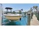 Exterior shot of a boat on a lift at a private dock, with palm trees in the background at 516 Tamiami S Trl # 306, Nokomis, FL 34275