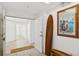 Inviting entryway with light wood floors, a surfboard, and an ocean-themed art piece at 516 Tamiami S Trl # 306, Nokomis, FL 34275