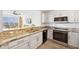 Stylish kitchen boasts granite counters, stainless appliances, and an open view of the living area at 516 Tamiami S Trl # 306, Nokomis, FL 34275