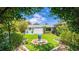Well-manicured backyard with a water feature, lush landscaping, and home exterior at 5238 Susan Ave, Sarasota, FL 34231