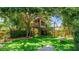A backyard with a large treehouse, monkey bars, and artificial turf, perfect for to play at 5238 Susan Ave, Sarasota, FL 34231
