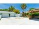 Spacious backyard with a basketball court, covered seating area, two-car garage, and lush landscaping at 5238 Susan Ave, Sarasota, FL 34231