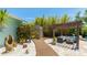 Inviting backyard featuring a pergola, outdoor seating, lush landscaping, and a unique stone sculpture at 5238 Susan Ave, Sarasota, FL 34231