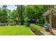 Lush backyard with a swing, treehouse, and lush greenery creating a serene outdoor space at 5238 Susan Ave, Sarasota, FL 34231