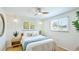 Bright bedroom with hardwood floors, ceiling fan, and light-filled windows creating a cozy and inviting atmosphere at 5238 Susan Ave, Sarasota, FL 34231