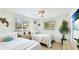Comfortable bedroom featuring hardwood floors, twin beds with stylish lamps, and coastal decor creating a tranquil retreat at 5238 Susan Ave, Sarasota, FL 34231